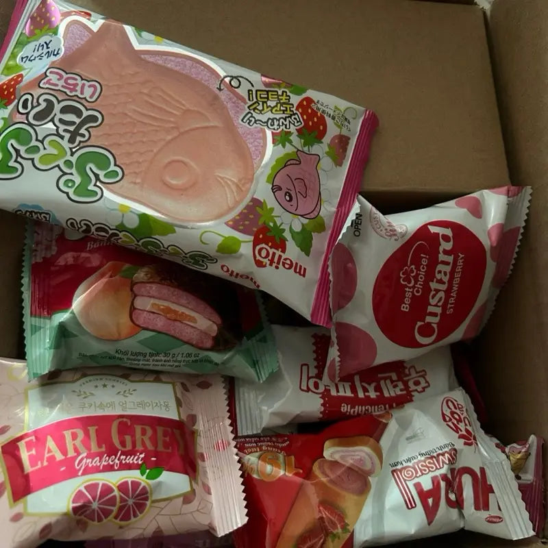 Pink Asian Snack Box with Ramen Drinks Includes Various Candy and Snacks Featuring Strawberry Flavors Sweet Dessert Macarons